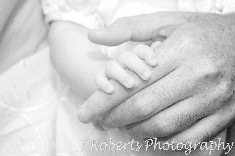 Baby holding her father's finger - baby portrait photography sydney
